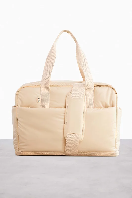 Travel bag with a detachable toiletry pouch for convenienceThe Expandable Duffle in Beige Travel bag with a detachable toiletry pouch for convenienceThe Expandable Duffle in Beige
