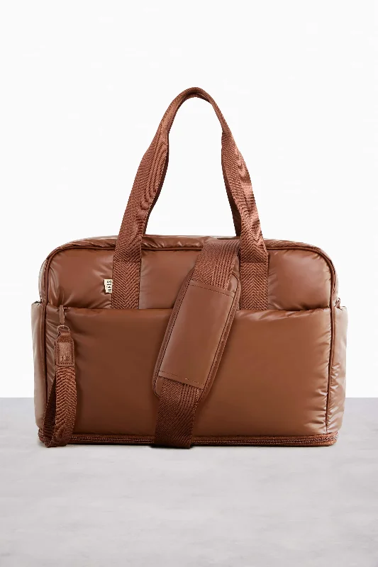 Designer - branded leather travel bag for luxury business travelersThe Expandable Duffle in Maple Designer - branded leather travel bag for luxury business travelersThe Expandable Duffle in Maple