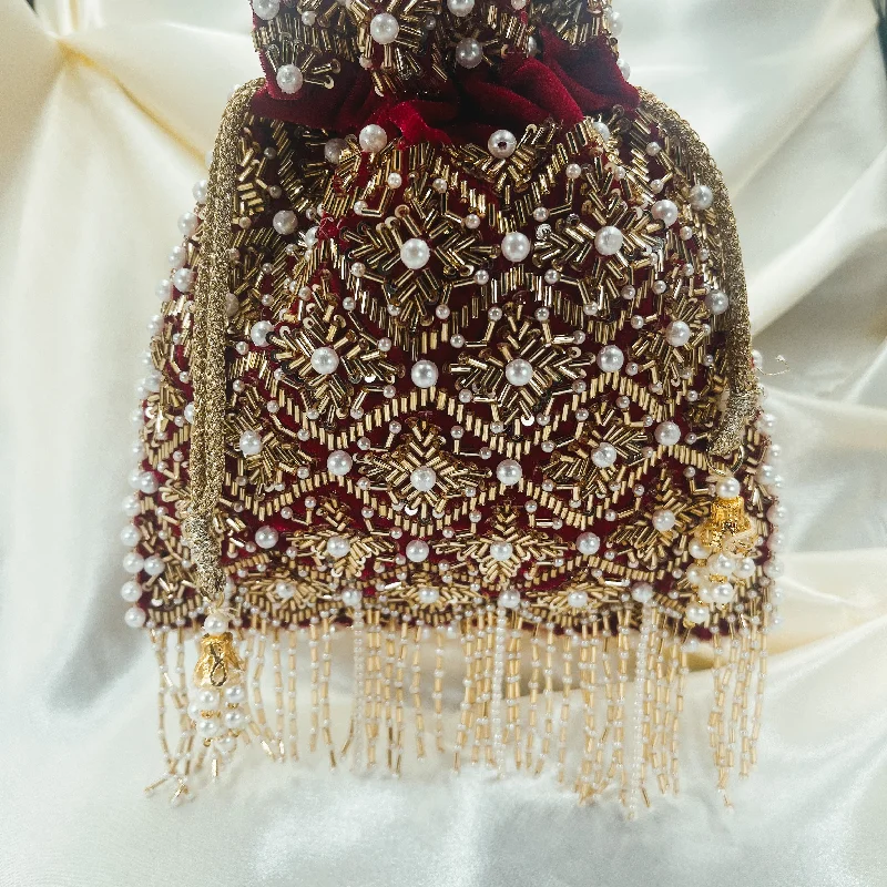Clutch with a removable strap to be used as a hand - held or cross - bodyNIA Potli (Magenta) Clutch with a removable strap to be used as a hand - held or cross - bodyNIA Potli (Magenta)